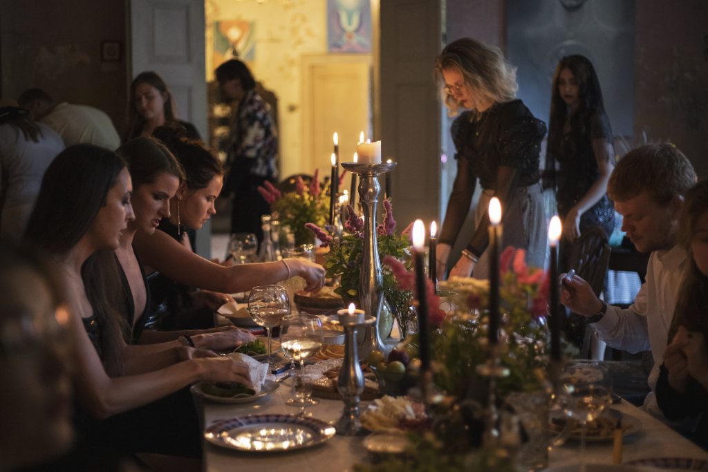 Richly served table with candles in Padure manor